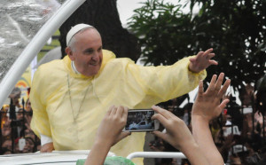 Pope Francis in his pope mobile waves to the crowd after the